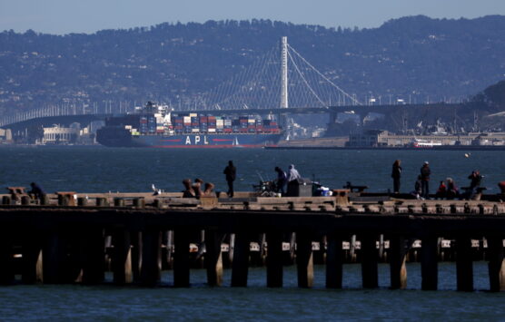 A container ship prepares to pass under the San Francisco-Oakland Bay Bridge.